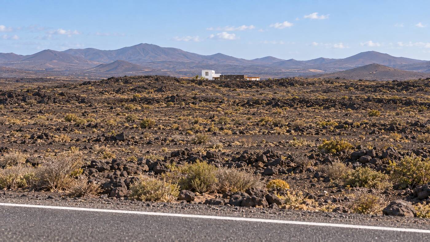 The estate seen from the LZ-2, a single white line far out in the black malpaís